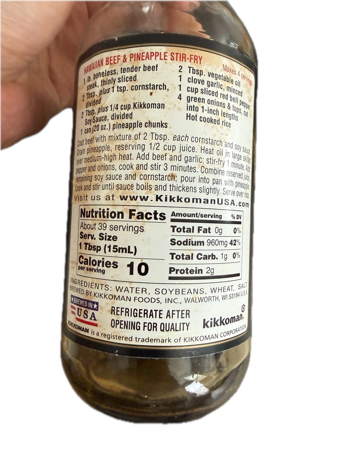 The back label of a Kikkoman soy sauce bottle showing an ingredient list of water, soybeans, wheat and salt