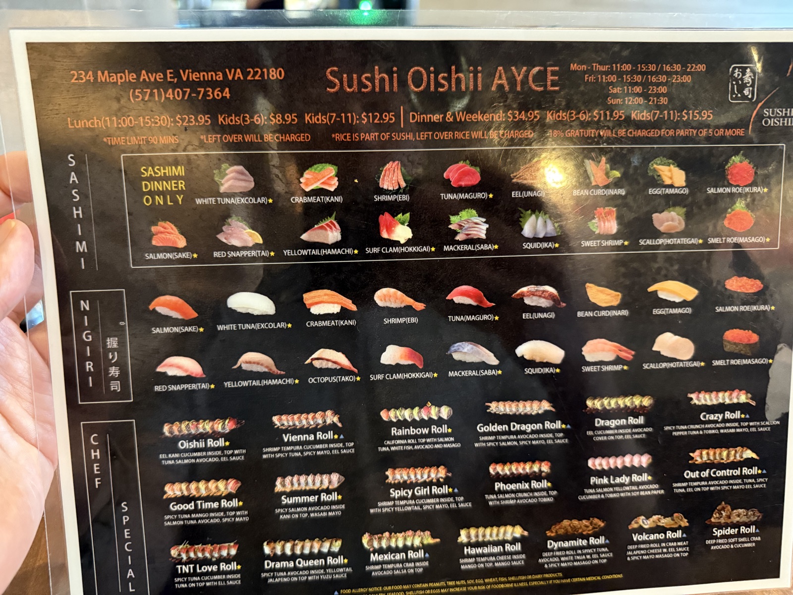 The Sushi Oishii AYCE menu board showing nigiri, sashimi and chef special rolls with lunch and dinner pricing